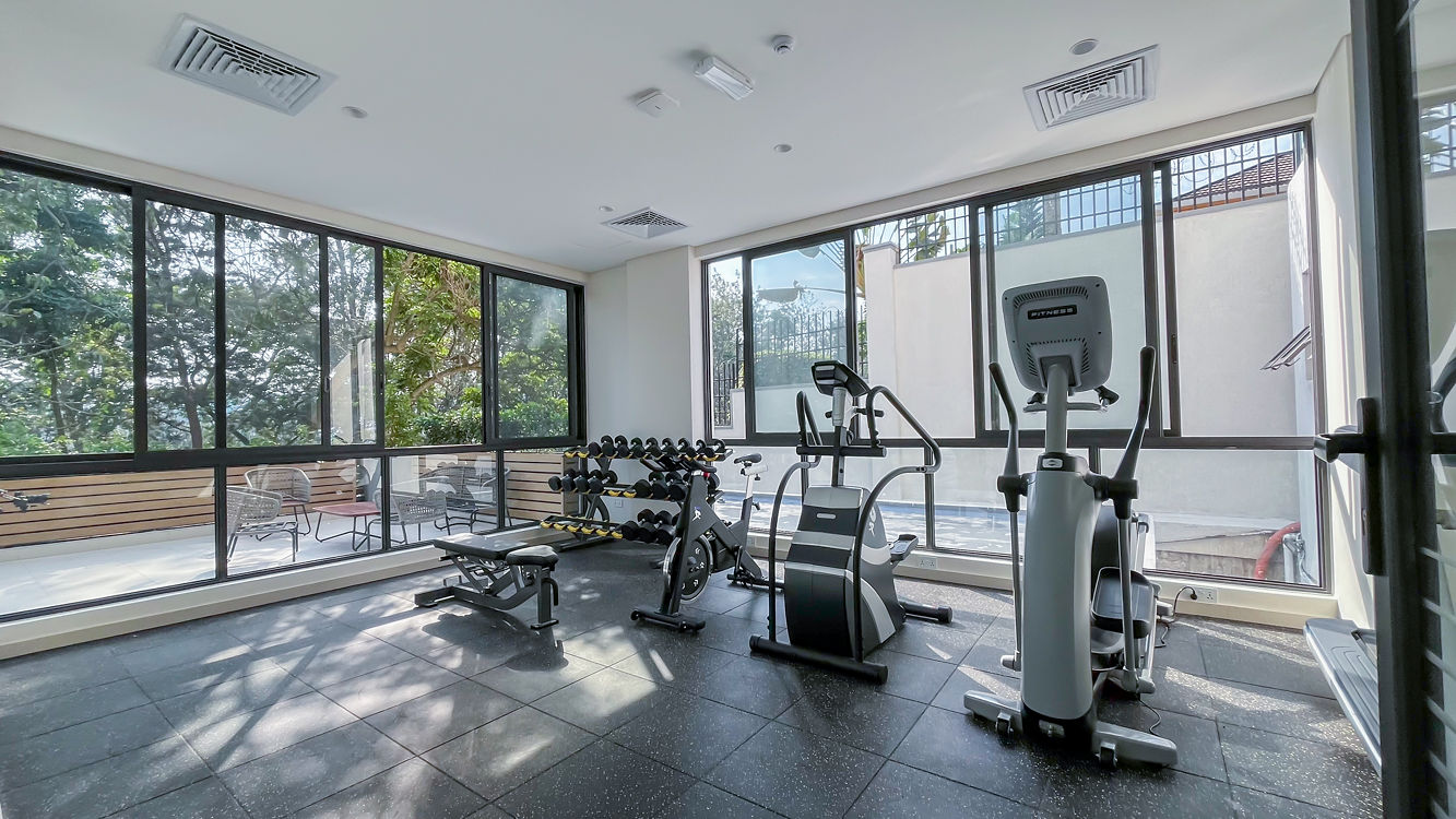Ohana Residence — residents' gym with garden views
